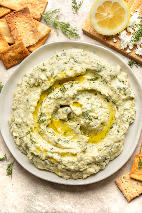 Overhead shot of Roasted Zucchini Dip in a serving dish with crackers on the side | thecozyapron.com