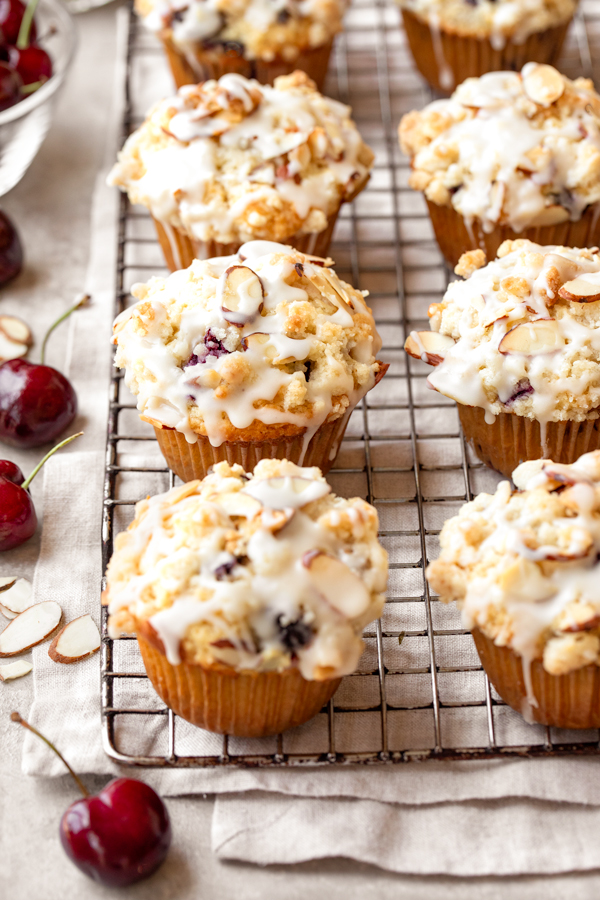 A fresh baked batch of Cherry Muffins cooling on a wire rack | thecozyapron.com