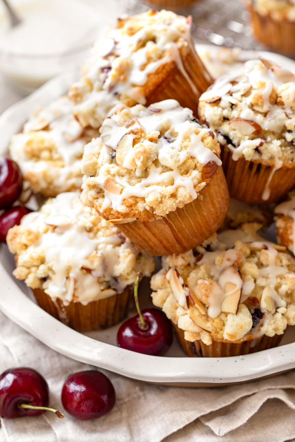 A stack of fresh baked Cherry Muffins on a serving plate | thecozyapron.com
