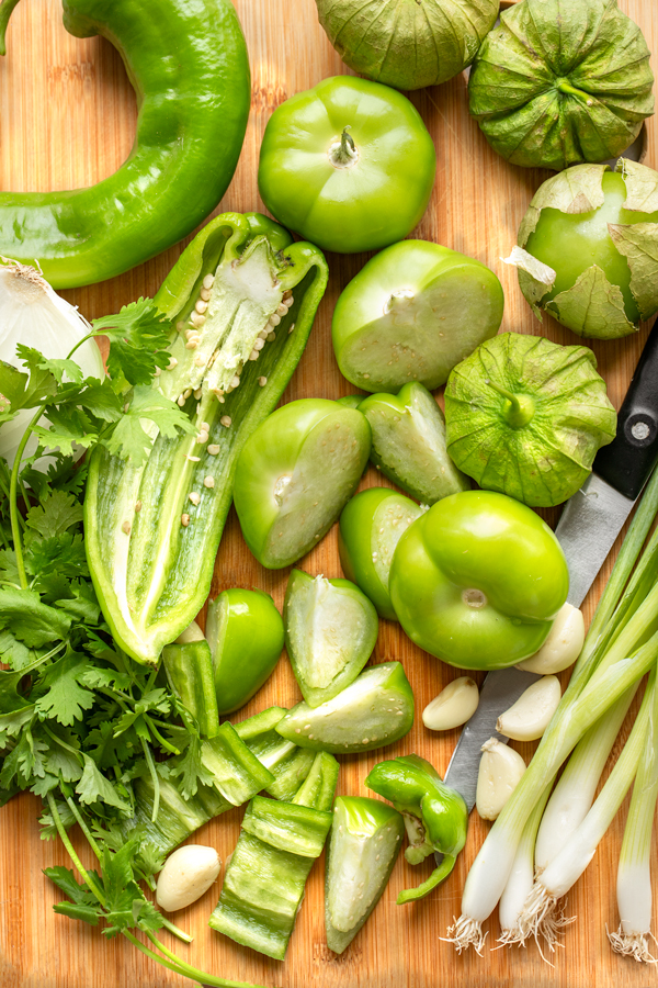 A cutting board full of fresh ingredients for Salsa Verde | thecozyapron.com