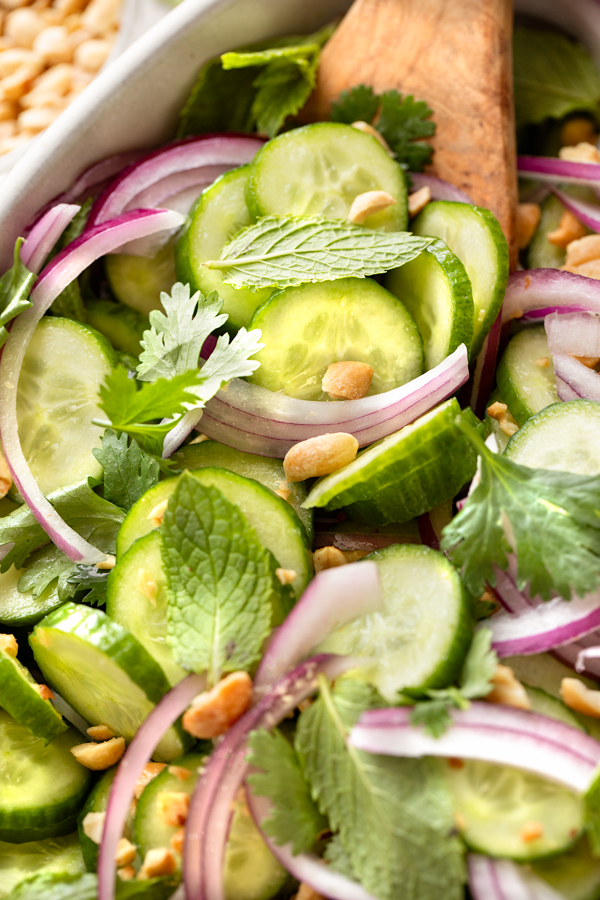 Closeup on a wooden spoonful of freshly made Thai Cucumber Salad | thecozyapron.com