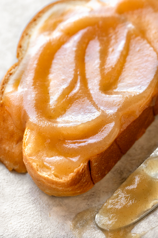 Closeup on Apple Butter spread on a warm slice of challah bread | thecozyapron.com