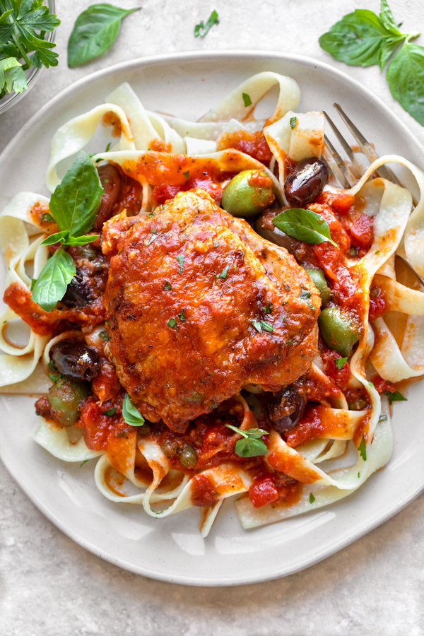 A serving of Chicken Puttanesca over tagliatelle pasta | thecozyapron.com