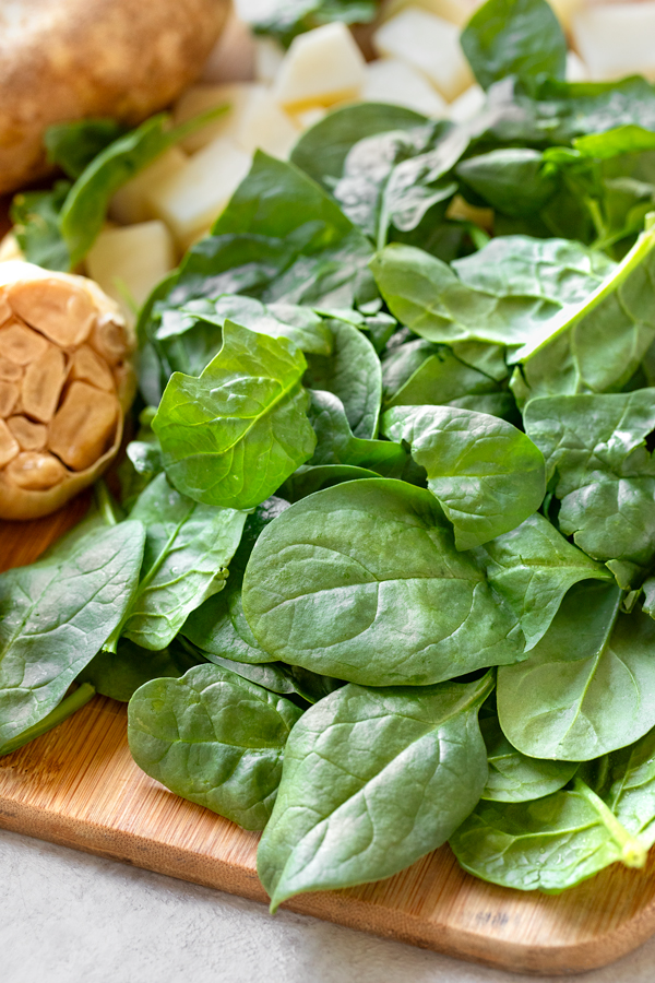 Vibrant, fresh spinach and roasted garlic, the main ingredients for Spinach Soup | thecozyapron.com