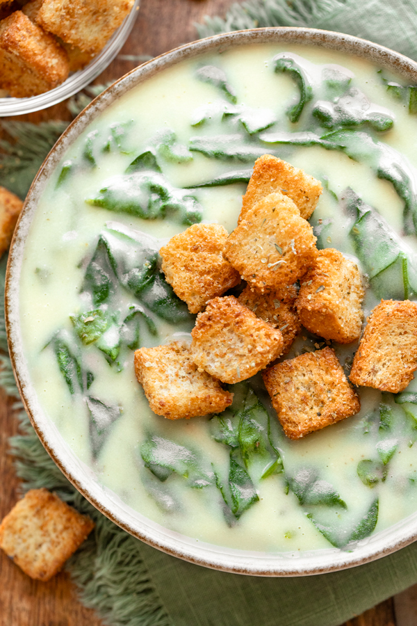 Overhead and closeup on a bowl of homemade Spinach Soup topped with crispy croutons | thecozyapron.com
